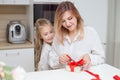 Daughter giving her mother a christmas present Royalty Free Stock Photo
