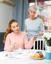 Daughter giving money to mother Royalty Free Stock Photo