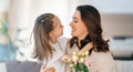 Daughter giving mother bouquet of flowers Royalty Free Stock Photo