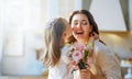 Daughter giving mother bouquet of flowers Royalty Free Stock Photo