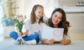 Daughter giving mother bouquet of flowers Royalty Free Stock Photo