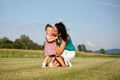 Daughter giving mother flowers