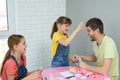 Daughter is going to punch dad in the forehead for a loss in a board game Royalty Free Stock Photo
