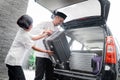 Daughter help her father carrying suitcase