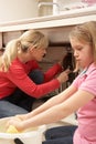 Daughter Helping Mother To Mop Up Leak