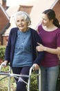 Daughter Helping Senior Mother To Use Walking Frame Royalty Free Stock Photo