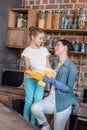 Daughter helping young mother with housework at home Royalty Free Stock Photo