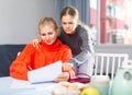 Daughter helps mom compose letter text
