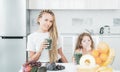 Daughter and her happy mother drinks green smoothie. Vegan meal and detox menu. Mother and daughter drinking green Royalty Free Stock Photo