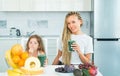 Daughter and her happy mother drinks green smoothie. Vegan meal and detox menu. Mother and daughter drinking green Royalty Free Stock Photo