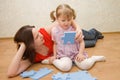 Daughter and her mother are solving puzzle Royalty Free Stock Photo