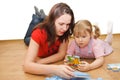 Daughter and her mother are solving puzzle Royalty Free Stock Photo