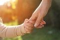 Daughter holding mother`s hand outdoors, closeup view Royalty Free Stock Photo