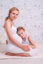 The daughter hugs the pregnant mother Royalty Free Stock Photo