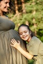 The daughter hugs the pregnant mother and waits for the appearance of her sister. Royalty Free Stock Photo