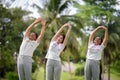 Daughter Joins Senior Parent for Heartwarming Exercise in Green Public Park, Senior Parent Exercise and Bonding Moments with