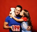 Daughter kisses her dad holding teddy bear. Royalty Free Stock Photo