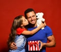 Daughter kisses her dad holding teddy bear. Royalty Free Stock Photo