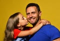 Daughter kisses her daddy in cheek. Child and father hug Royalty Free Stock Photo