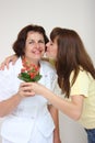 A daughter kissing her mother Royalty Free Stock Photo