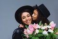 daughter kissing her mother while she holding bouquet Royalty Free Stock Photo
