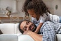 Daughter lying on daddy back enjoy time together at home Royalty Free Stock Photo