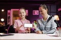 Daughter and mom being sponsored by partnering brand to do mockup mobile phone unboxing content Royalty Free Stock Photo