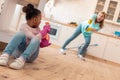 Daughter and mother diffusing cleaning spray on each other while cleaning Royalty Free Stock Photo