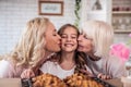 Daughter, mother and grandmother cooking on kitchen. Women generation baking together.