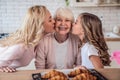 Daughter, mother and grandmother cooking on kitchen. Women generation baking together.