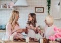 Daughter, mother and grandmother cooking on kitchen. Women generation baking together.