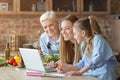 Daughter, mom and granny having fun while cooking Royalty Free Stock Photo