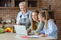 Daughter, mother and grandmother having fun while cooking Royalty Free Stock Photo