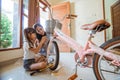 Daughter and mother have fun installing their new bicycle basket