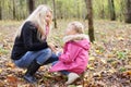 Daughter and mother hunker down and look at each other