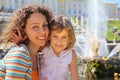 Daughter with mother near fountains of Petergof