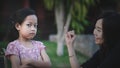 The daughter petulant her mother with a grumpy expression. Mom tried to apologize and reconcile her by showing a little finger Royalty Free Stock Photo