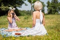 Daughter photographer and mother model playing outdoors. Royalty Free Stock Photo