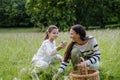 Daughter picking flowers, giving them to mother. Concept of family ecological hobby in nature. Mother& x27;s Day.