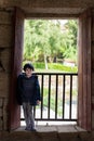 Daughter pose for a photo in window with forest and river in background Royalty Free Stock Photo