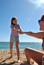 Daughter pulling the arm of her mother Royalty Free Stock Photo