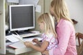 Daughter Reading Book Whilst Mother Works In Home Office Royalty Free Stock Photo