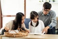 Daughter reading with dad and mom Royalty Free Stock Photo