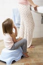 Daughter Reluctant To Brush Teeth With Mother Royalty Free Stock Photo