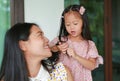 Daughter`s is combing mother hair after bathing Royalty Free Stock Photo