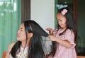 Daughter`s is combing mother hair after bathing Royalty Free Stock Photo