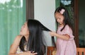 Daughter`s is combing mother hair after bathing Royalty Free Stock Photo