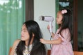 Daughter`s is combing mother hair after bathing Royalty Free Stock Photo