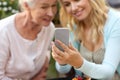 Daughter and senior mother taking selfie at park Royalty Free Stock Photo