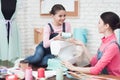 Daughter sits on a table and drops mom`s thread.